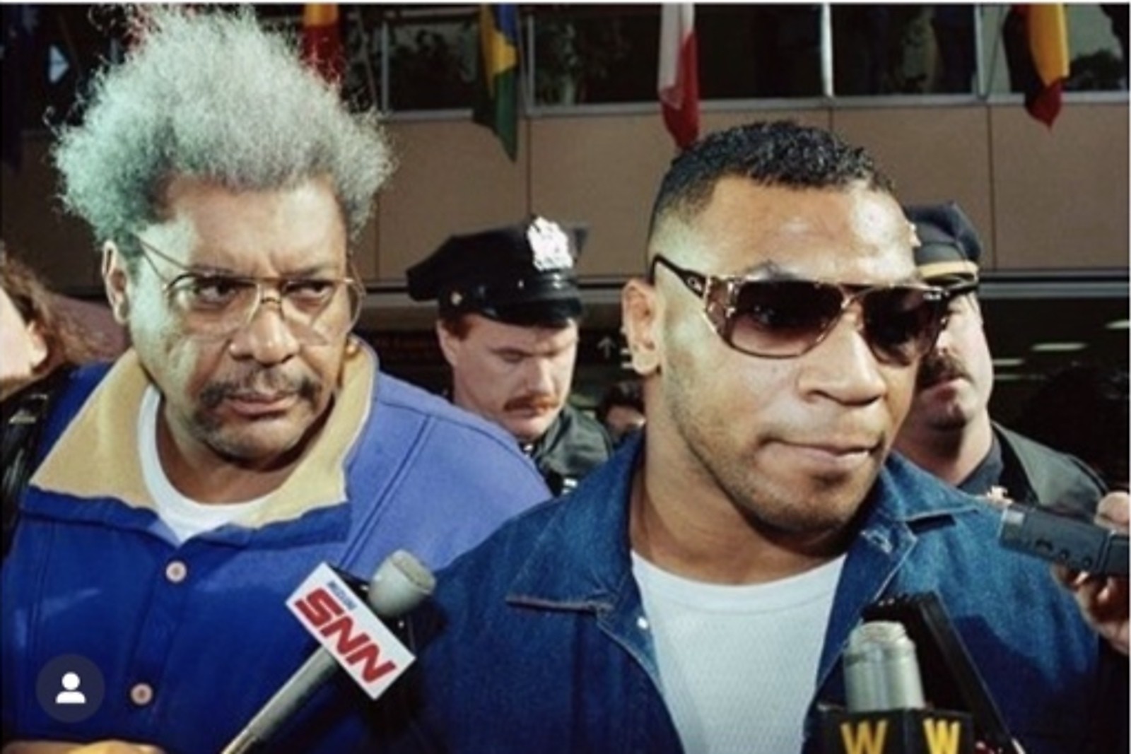 Don King and Mike Tyson surrounded by press
